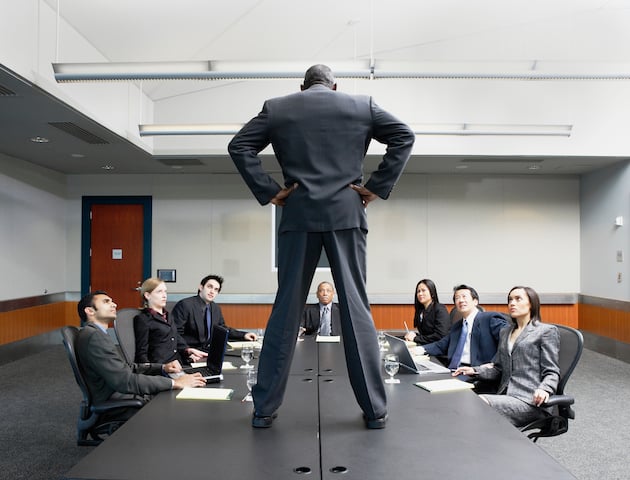 Businessman standing on conference table