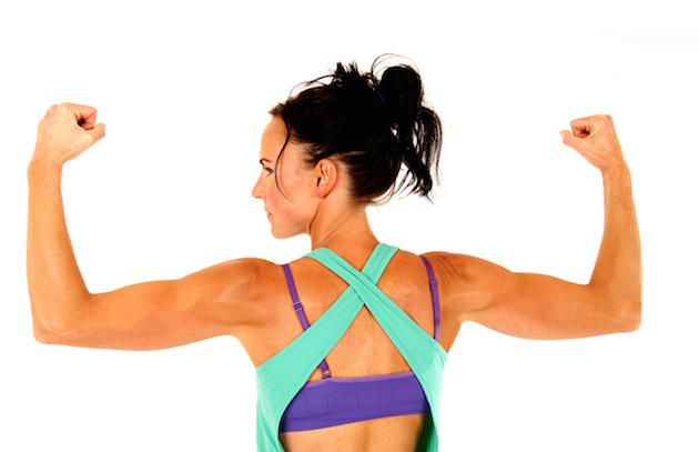Fit woman working out flexing arm muscles from behind