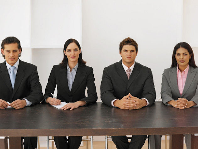 Front view portrait of four business executives sitting in a line
